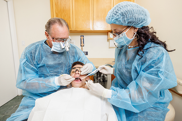 Patient at teeth treatment procedure